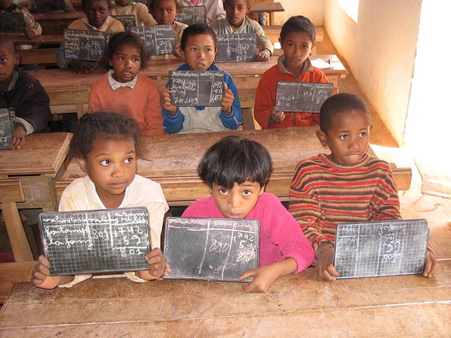 Image representing 'Education as a Basic Human Right'. Children display their writing slates in a classroom. Image credit: Global Partnership for Education. https://www.globalpartnership.org/blog/education-human-right