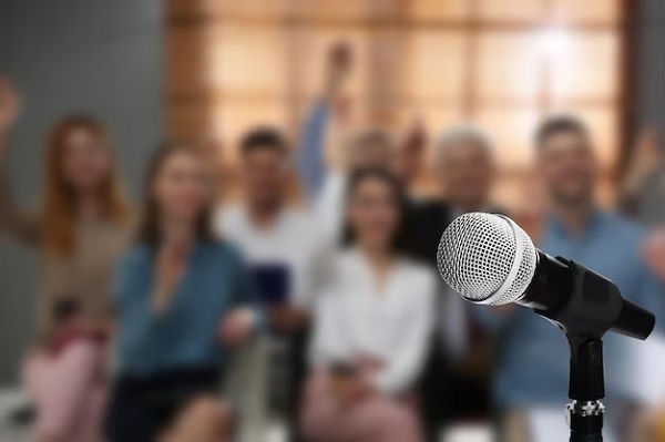 Short Women Empowerment Speech in English - 150 Words, 200 Words, 250 Words, 300 Words, 400 Words and 500 Words. Women Empowerment Speech Images/Photos: 3. A blurred photo of excited women after an empowerment speech was delivered. Photo credit: Freepik. https://img.freepik.com/premium-photo/modern-microphone-people-business-training-indoors-closeup_495423-31925.jpg