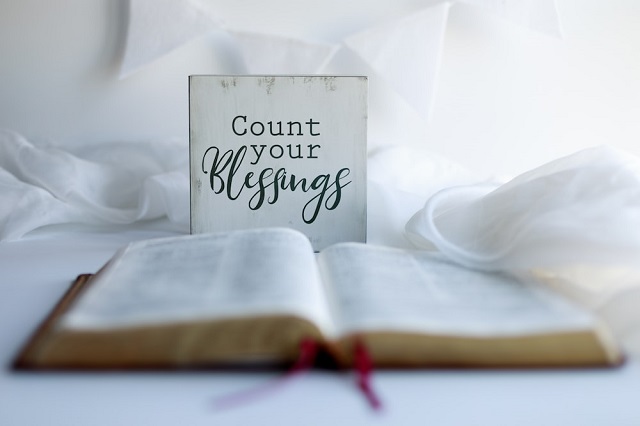 Bible Quotes for Relief from Hardship and Difficult Times: Bible Quotes Images/Photos: 2. A photo of 'Count Your Blessings' lettering on a card beside a Bible. Photo credit: Splash. https://unsplash.com/s/photos/bible-quotes
