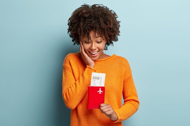 Canada Permanent Resident Visas. Canada Visa and Immigration Images/Photos: 2. A young female Canada traveler with an approved permanent resident visa. Photo credit: wayhomestudio at Freepik. https://www.freepik.com/free-photo/young-woman-with-afro-haircut-wearing-orange-jumper_11265605.htm#