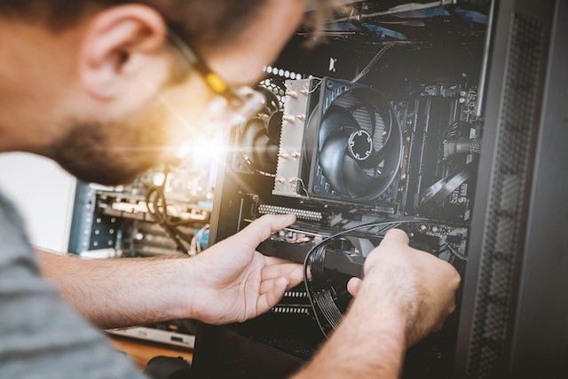 Computer Science Engineering Images/Photos: 1. A photo of a a computer engineer installing microchip in a computer system. Photo credit: JESHOOTS on Unsplash. https://unsplash.com/photos/sMKUYIasyDM