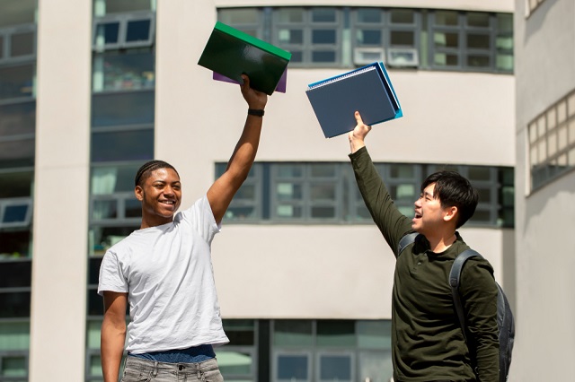 Private Institutions Scholarship Images/Photos: 2. A photo of two scholarship students celebrating their award. Photo credit: Freepik. https://www.freepik.com/free-photo/college-students-cramming-outdoor_31237832.htm#