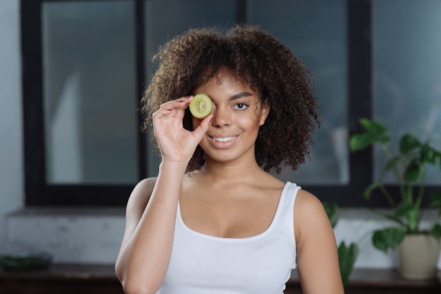 Kiwi Fruits - Health Benefits Photos: 1. A photo depicting good eye sight and overall wellbeing as part of the health benefits of kiwi fruits. https://www.freepik.com/free-photo/woman-with-cucumber_1999461.htm#