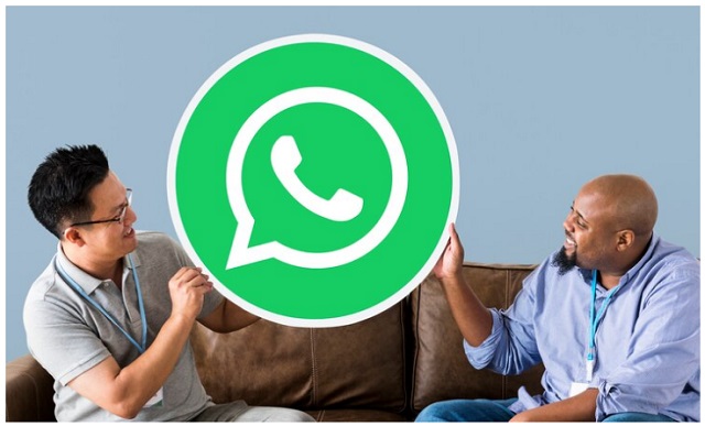 Images: 1 - WhatsApp Original vs WhatsApp Plus – Messaging App Comparison Visual. Two people holding a large WhatsApp logo, symbolizing a discussion about WhatsApp Original vs WhatsApp Plus and their key differences.