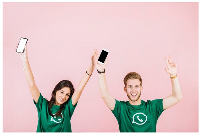 Images: 3 - WhatsApp Original vs WhatsApp Plus – Comparing Apps for a Better Messaging Experience. Two happy people in green WhatsApp shirts holding smartphones and celebrating, symbolizing the comparison of WhatsApp Original vs WhatsApp Plus features.