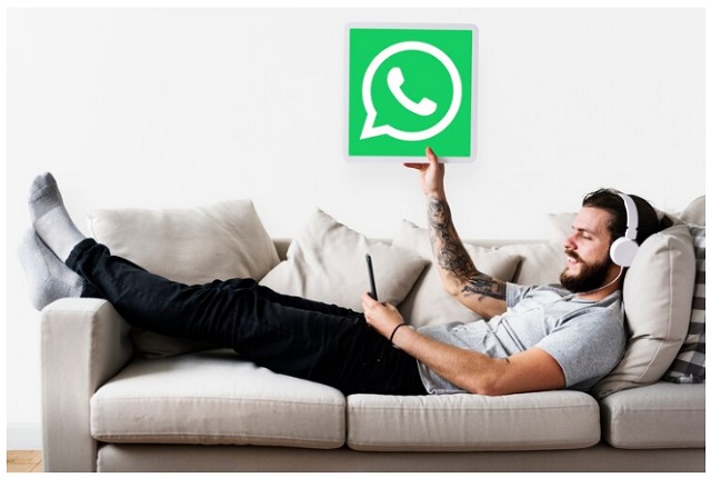 WhatsApp Original vs Images: 2 - WhatsApp Plus – User Experience and Key Differences. Man relaxing on a sofa using a smartphone with WhatsApp logo above him, symbolizing the choice between WhatsApp Original and WhatsApp Plus features.