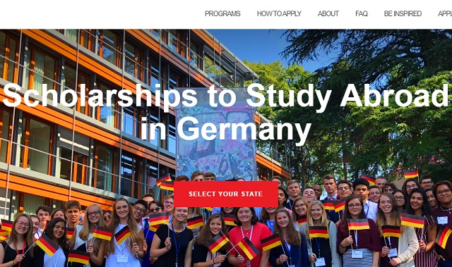 Diverse group of Congress-Bundestag Youth Exchange (CBYX) scholarship recipients, including US high school and post-secondary students, holding small German flags and standing in front of a modern school building. The image features the text "Scholarships to Study Abroad in Germany" and a prompt to "Select Your State." This visual promotes the fully funded CBYX 2025/2026 exchange program.