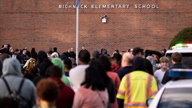 Today’s Weird News blog post of Wednesday, January 18, 2023: Picture: A 6-year-old shot his teacher in class with mum’s gun. Image credit: Sky News: Students and police gather outside the school building after the shooting incident