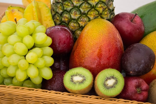 Photo byJonas Kakaroto on Unsplash. Image of a variety of fruits - kiwifruits, uva, maca grapefruit, apple, bananas, mangoes, pears in their varying colours.