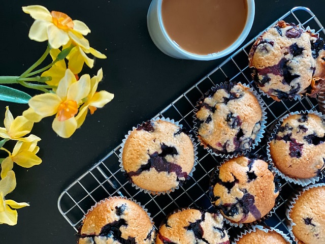 Photo of Blueberry Muffins Served with a Glass of Tea. Photo by Nothing aholic on Unsplash