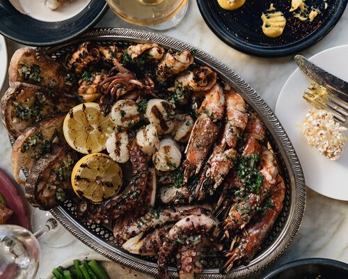 Image of Chicama Seafood Platter made from grilled prawns, octopus, squid, scallops, sea bass fillet, roasted lemon, caper butter and sourdough / 95. 